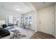 Cozy living space with large window, sliding glass door, and comfortable seating arrangement at 13625 E 103Rd Pl, Commerce City, CO 80022