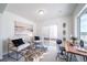 Comfortable living space with large window, sliding glass door, and stylish furniture at 13625 E 103Rd Pl, Commerce City, CO 80022