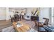 Bright living area features modern decor, wood-look flooring, and an open concept kitchen at 13625 E 103Rd Pl, Commerce City, CO 80022