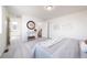 This carpeted main bedroom leads to the bathroom, and has a decorative console table and a window at 13625 E 103Rd Pl, Commerce City, CO 80022