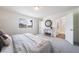 Open main bedroom with an ensuite bathroom, large window, and stylish decor at 13625 E 103Rd Pl, Commerce City, CO 80022