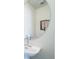 Modern powder room featuring a sleek sink, mirror, and wall-mounted decor at 13625 E 103Rd Pl, Commerce City, CO 80022