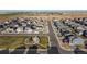 An aerial shot shows a well-planned community with manicured lawns, modern homes, and community park at 45810 Laceleaf Dr, Bennett, CO 80102