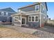 Backyard featuring gray siding, stone, and wood fence, and ample sunlight at 45810 Laceleaf Dr, Bennett, CO 80102