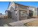 Backyard view features gray siding, stone, and wood fence, and ample sunlight at 45810 Laceleaf Dr, Bennett, CO 80102