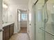 Bathroom featuring double sinks, tile floor and shower with glass door at 45810 Laceleaf Dr, Bennett, CO 80102