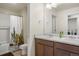 Bright bathroom featuring a double sink vanity and a tub with a fun, patterned shower curtain at 45810 Laceleaf Dr, Bennett, CO 80102