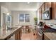 Bright dining area with modern table, seating, and view of the backyard, next to the kitchen at 45810 Laceleaf Dr, Bennett, CO 80102