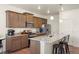 Well-appointed kitchen with granite countertops, stainless steel appliances, and breakfast bar seating at 45810 Laceleaf Dr, Bennett, CO 80102