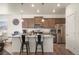 Modern kitchen featuring granite countertops, stainless steel appliances, and a breakfast bar at 45810 Laceleaf Dr, Bennett, CO 80102