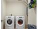 Bright laundry room with front-loading washer and dryer, and space for storage at 45810 Laceleaf Dr, Bennett, CO 80102