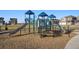 Community playground features slides and climbing structures creating fun for children in a Gathering-friendly setting at 45810 Laceleaf Dr, Bennett, CO 80102