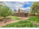 Charming brick home featuring a spacious backyard with a brick patio, beautiful lawn, and mature trees at 1900 Magnolia St, Denver, CO 80220