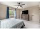 Inviting bedroom with carpet flooring, a ceiling fan, and large windows with views to outside the home at 1900 Magnolia St, Denver, CO 80220