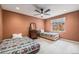 Inviting bedroom features two beds, ceiling fan, and a vintage dresser with mirror at 1900 Magnolia St, Denver, CO 80220
