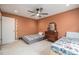 Comfortable bedroom showcasing twin beds, ceiling fan, and charming antique dresser at 1900 Magnolia St, Denver, CO 80220