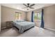 Comfortable bedroom featuring carpet flooring, a ceiling fan, and large windows for natural light at 1900 Magnolia St, Denver, CO 80220
