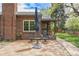 Inviting brick patio with seating, creating a cozy outdoor space to relax outside this beautiful brick home at 1900 Magnolia St, Denver, CO 80220
