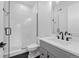 Clean bathroom with gray vanity, glass shower, and hexagon tile floor at 8077 Raphael Ln, Littleton, CO 80125