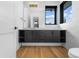 Modern bathroom with floating vanity, sleek hardware, and a window at 8077 Raphael Ln, Littleton, CO 80125