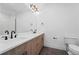 Elegant bathroom with double sinks, modern vanity, and matte black fixtures at 8077 Raphael Ln, Littleton, CO 80125