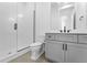 Modern bathroom with gray vanity, glass shower, and white toilet at 8077 Raphael Ln, Littleton, CO 80125