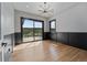 Bright bedroom with hardwood floors, sliding door to deck, and mountain views at 8077 Raphael Ln, Littleton, CO 80125