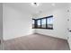 Bright bedroom with carpet flooring and large window offering scenic views at 8077 Raphael Ln, Littleton, CO 80125