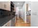 Butlers pantry with dark countertops and stainless steel appliances at 8077 Raphael Ln, Littleton, CO 80125