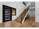Light and airy entryway with hardwood floors and a modern staircase at 8077 Raphael Ln, Littleton, CO 80125