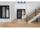 Bright entryway with hardwood floors and modern staircase at 8077 Raphael Ln, Littleton, CO 80125