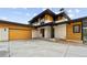 Modern two-story home with light stone and wood accents at 8077 Raphael Ln, Littleton, CO 80125