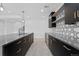 Contemporary kitchen with dark cabinetry and geometric backsplash at 8077 Raphael Ln, Littleton, CO 80125
