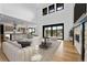 Spacious living area with a stone fireplace and access to balcony at 8077 Raphael Ln, Littleton, CO 80125