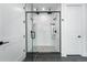 Large walk-in shower with double shower heads and geometric tile at 8077 Raphael Ln, Littleton, CO 80125