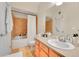 Cozy bathroom featuring orange tile, a shower with a curtain, and a vanity with a sink at 17497 Nature Walk Trl # 302, Parker, CO 80134