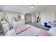 Bright bedroom featuring a bed, dresser, closet, and a work area at 17497 Nature Walk Trl # 302, Parker, CO 80134