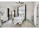 Bright bedroom with large window, a sliding glass door, and neutral decor at 17497 Nature Walk Trl # 302, Parker, CO 80134