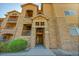 Close-up of the condo entrance featuring stone accents, stairs, and unit number signs at 17497 Nature Walk Trl # 302, Parker, CO 80134