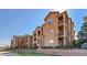 Attractive multi-story condo building with stone facade, balconies, and manicured landscaping at 17497 Nature Walk Trl # 302, Parker, CO 80134