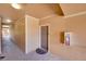 Well-lit condo hallway with neutral walls, unit door, and fire extinguisher at 17497 Nature Walk Trl # 302, Parker, CO 80134