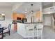 Open kitchen with breakfast bar, stylish pendant lights, and modern appliances at 17497 Nature Walk Trl # 302, Parker, CO 80134