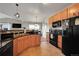 Contemporary kitchen with black appliances, tiled backsplash, and granite countertops at 17497 Nature Walk Trl # 302, Parker, CO 80134