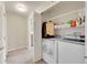 Convenient laundry area with washer, dryer, and storage shelving for easy organization at 17497 Nature Walk Trl # 302, Parker, CO 80134
