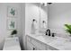 A modern bathroom featuring a marble countertop, sleek black faucet, and decorative plant accents at 12054 E 3Rd Ave, Aurora, CO 80011