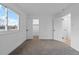 Clean bedroom with plush carpeting, a large window, and a view into an open closet at 12054 E 3Rd Ave, Aurora, CO 80011
