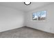 Bedroom featuring neutral carpet, a window, and simple features at 12054 E 3Rd Ave, Aurora, CO 80011