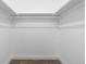 Walk-in closet featuring neutral-toned carpet, white walls, and shelving with hanging rods at 12054 E 3Rd Ave, Aurora, CO 80011
