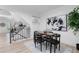 Bright dining room features modern lighting, wood floors, and a staircase at 12054 E 3Rd Ave, Aurora, CO 80011