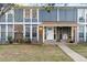 Charming two-story townhome with a well-maintained lawn and inviting front entrance at 12054 E 3Rd Ave, Aurora, CO 80011